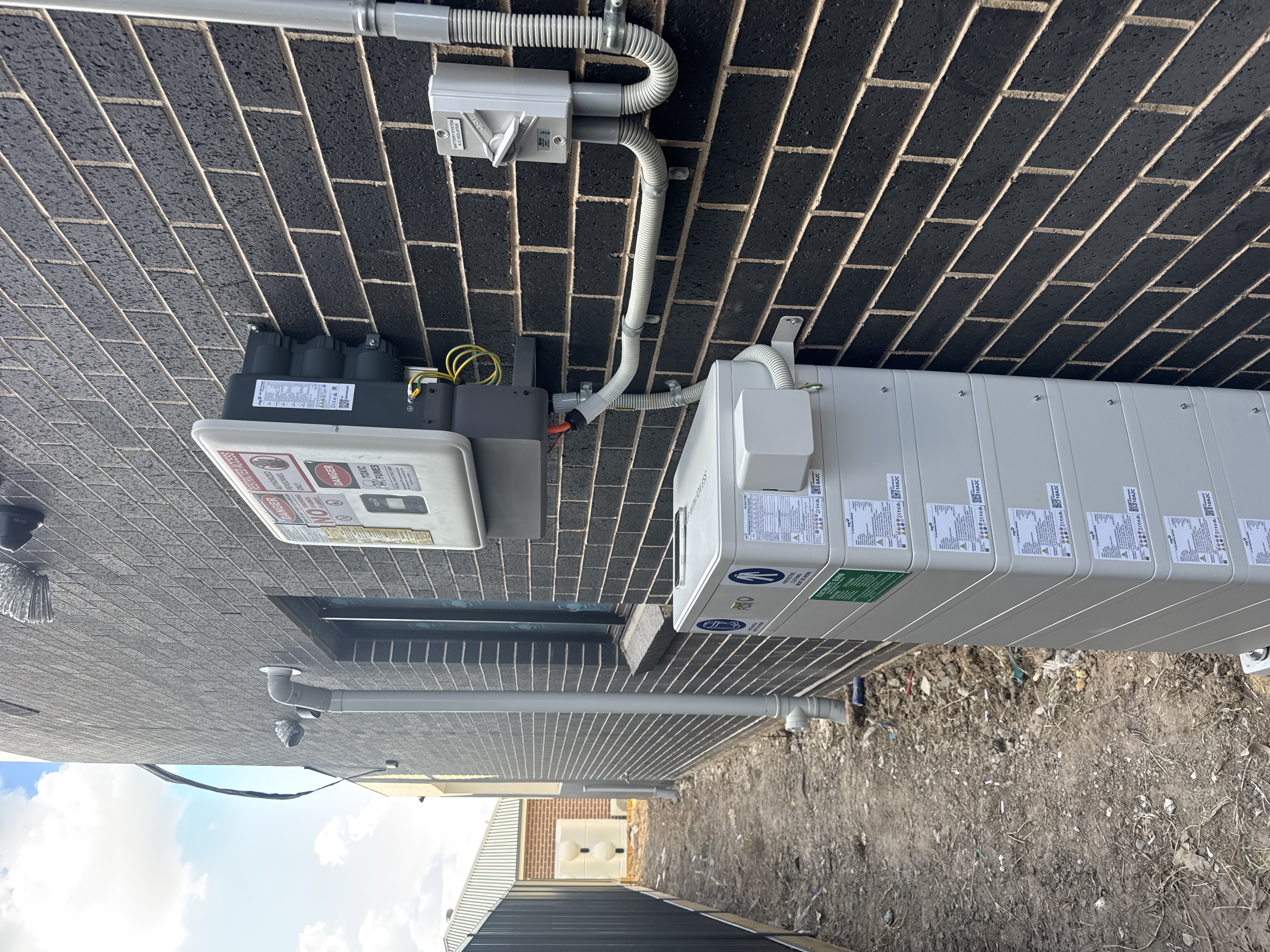 Battery system on dark brick wall
